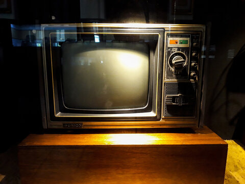 Old TV on old wood. Vintage old television. Still life in Museum Mandiri. 
