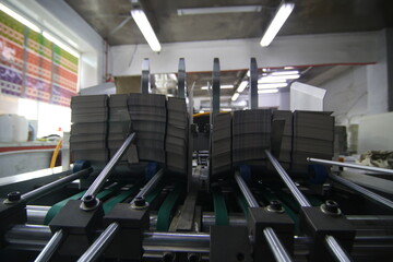 Fototapeta premium stacks of printed sheets of cardboard on wooden pallets closeup. printing industry