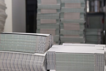stacks of printed sheets of cardboard on wooden pallets closeup. printing industry