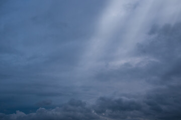 Blue sky background with white dramatic clouds and sunlight, vast sky background