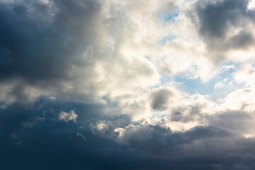 Naklejka na ściany i meble Blue sky background with white dramatic clouds and sunlight, vast sky background