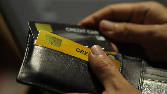 hand holding credit card for shoping from wallet.