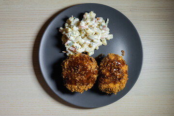Two minced meat cutlets (menchikatsu) with pasta salad.