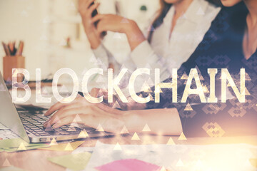 Double exposure of woman hands typing on computer and crypto market theme hologram drawing....