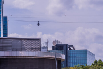 Cable car above city buildings.
