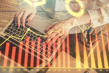 Double exposure of woman hands typing on computer and forex chart hologram drawing. Stock market invest concept.