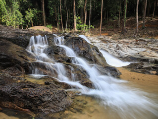 Fototapeta premium Waterfall found in tropical rainforest in malaysia