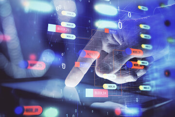 Fototapeta premium Multi exposure of man's hand holding and using a digital device and data theme drawing. Innovation concept.