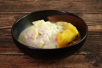 Durian sticky rice in coconut milk and durian creamy sauce. One of most famous Thai dessert in summer of durian season. Selective focus, space for texts
