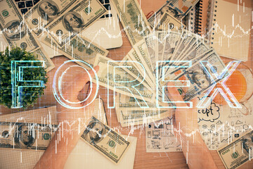 Multi exposure of financial graph drawing hologram and USA dollars bills and man hands. Analysis concept.