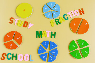 Close up mathematical fractions and colorful letters on yellow background. Creative, fun...