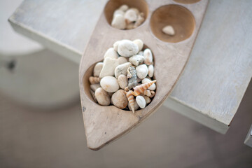 Fototapeta na wymiar Shell and beach small stone in the wooden tray for decoration
