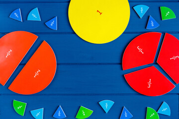 Close up mathematical fractions and colorful letters on blue background. Creative, fun mathematics...