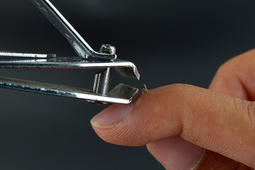 A nail clipper used to trim hangnails isolated on the black background.