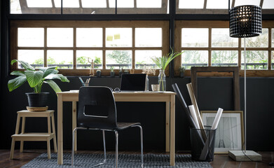 Modern home office creative space perfect for working from home lifestyle with laptop on the desk and sofa in the living room, Quarantine isolation during the Coronavirus (COVID-19) health crisis