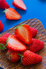 strawberries on a wood plate close up