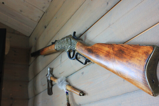 The old gun on the wood wall