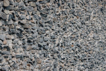 Stone wall. Detailed texture of a wall lined with cobblestones with cement.
