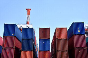 Fototapeta premium Stacked cargo at maritime transport terminal: shipping industry