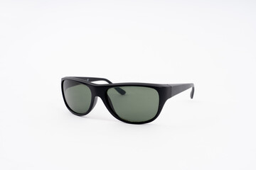 black plastic sunglasses on white background. selective focus.