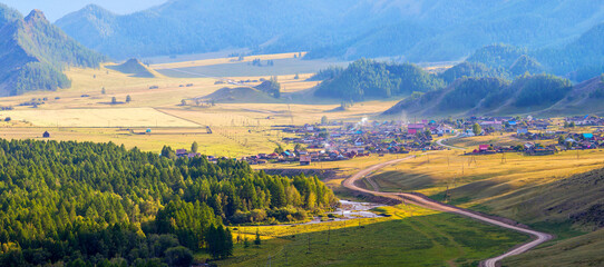 Rural landscape, Altai mountains. Evening light in a picturesque valley. Panoramic view. 