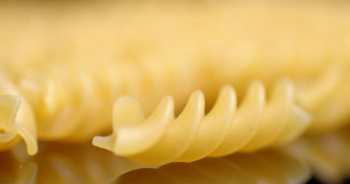 One dry fusilli pasta on the table swinging.