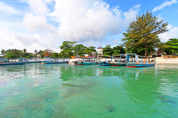 Fototapeta na wymiar Colorful boats and sandy beaches in Belitung, Indonesia.