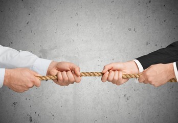 Business people pulling the rope in opposite directions - obrazy, fototapety, plakaty