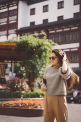 brunette girl exploring a local square in Shanghai China during autumn