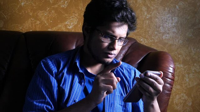 Young Man In Casual Dress Use Smart Phone At Night 