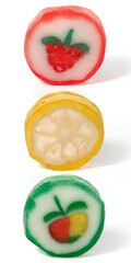 Three round fruit caramels on a white background