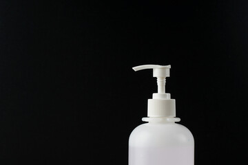 Sanitiser bottle over the black background to keep hand hygiene. New normal life during coronavirus disease cover-19 pandemic