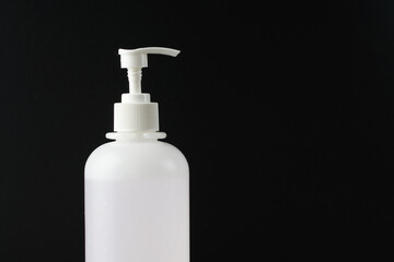 Sanitiser bottle over the black background to keep hand hygiene. New normal life during coronavirus disease cover-19 pandemic