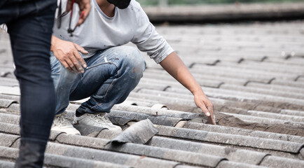 Male handyman repairing the roof.
