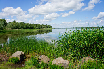 Landscape with a river and beautiful blue sky and white clouds. Ukraine, the Dnieper River.