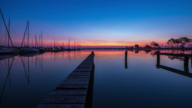 Complete Sunrise with mirror reflection, boats and steg