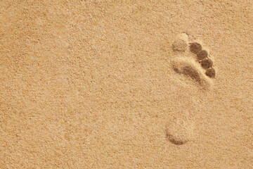 Fototapeta na wymiar Footprints of human feet on the sand.