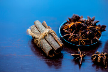 Face mask for wrinkles on the wooden surface consisting of some cinnamon sticks, water, and star anise seed powder.