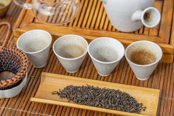 Tea ceremony at the outdoors camping site. Still life of appliances for tea consumption laid down on the tea table with tea and incense sticks.