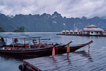Fototapeta na wymiar Traditional wooden boats on wharf in Cheow Lan Lake, Khao sok national park, Thailand.