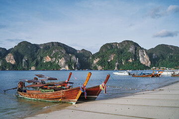 Travel by Thailand. Landscape with traditional longtail fishing and tourists boat on the sea beach.