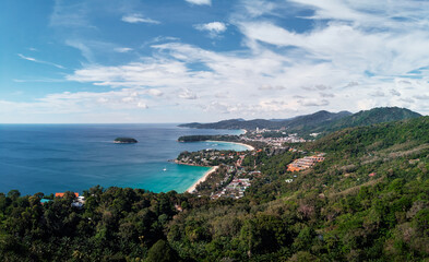 Kata and Karon beach view point. Beautiful landscape with ocean shore, green hills, cloudy sky. Phuket, Thailand.