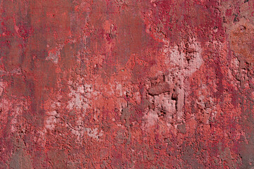 Rusty damaged cement wall with peeling paint and stains