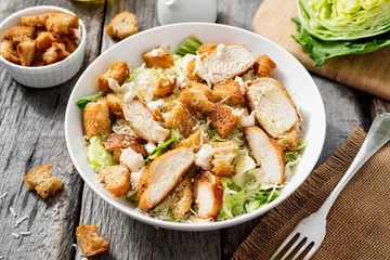 Foto auf Glas Classic caesar salad with grilled chicken fillet and parmesan cheese.   © Nelea Reazanteva