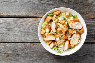 Classic caesar salad with grilled chicken fillet and parmesan cheese. top view	
 - obrazy, fototapety, plakaty