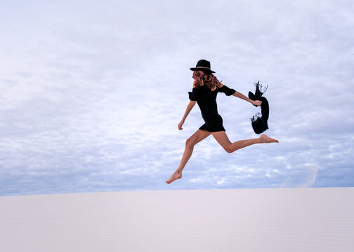 girl jumping on the beach of White Sands National Park