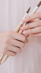 beautiful hand of a girl with a ring on her finger holding a brush in her hands