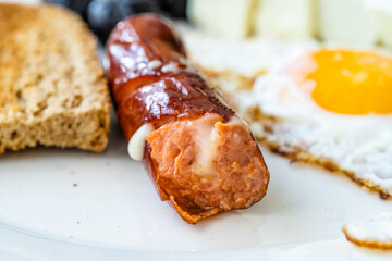 Bratwurst Sausage Filled with Emmental Cheese in Breakfast Plate.