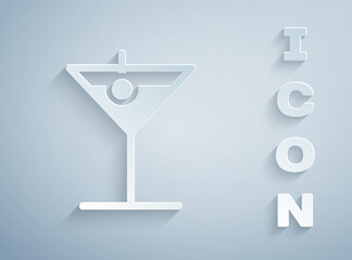 Paper cut Martini glass icon isolated on grey background. Cocktail icon. Wine glass icon. Paper art style. Vector Illustration.