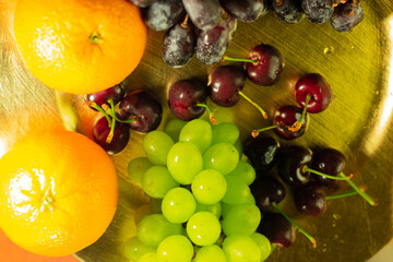 overhead view of grapes cherries orange and other fruit